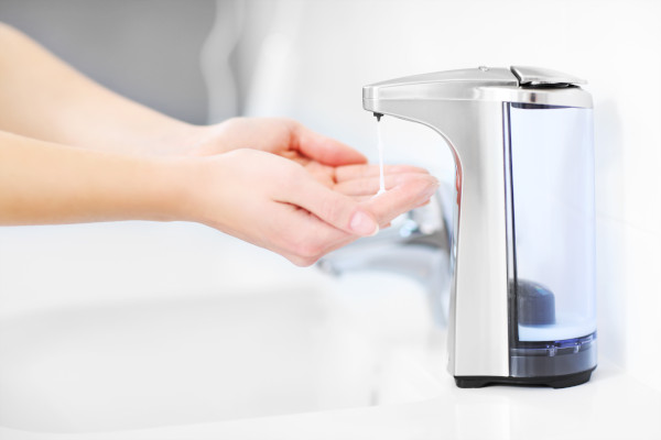 Person using a touchless soap dispenser